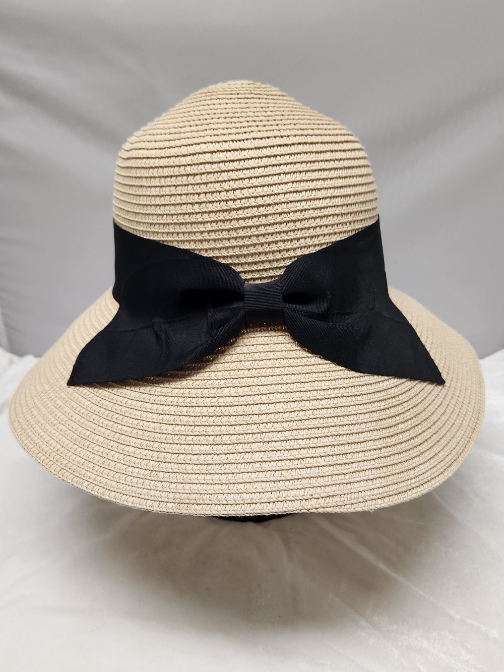 Wide-Brim Beige Straw Hat with Black Bow Accent